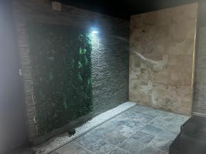 a room with a green wall with a light at Casa Toñi Airport in Agüimes +39 photos