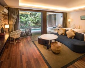 a living room with a couch and a table at Watermark Hotel & Spa Bali in Jimbaran +147 photos