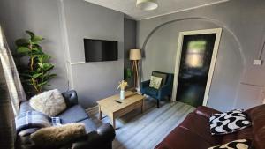 a living room with a couch and a table at Entire 3 bed house in Gloucester in Gloucester