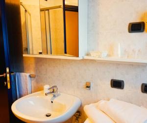 a bathroom with a sink and a mirror and towels at Residence Biancaneve in Aprica +63 photos