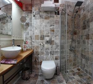 a bathroom with a toilet, sink, and tub at SuB Karakoy - Special Category in Istanbul