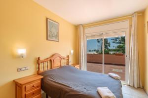 a bedroom with a bed and a sliding glass door at Villa Santa Susanna 18 in Santa Susanna +34 photos