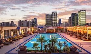 a pool on the roof of a building with a city skyline at Incheon Songdo Stay31 in Incheon