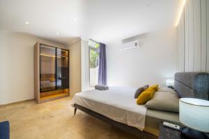 a bedroom with a bed and a chair and a window at Villa Gunes in Kalkan