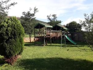 a playground with a slide in a yard at Klein Paradys Parys in Parys