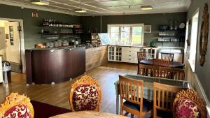 a restaurant with a table and chairs and a kitchen at Nidaros Pilegrimsgård in Trondheim