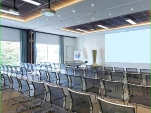 an empty room with chairs and a podium in it at Novotel Avignon Nord in Sorgues +109 photos