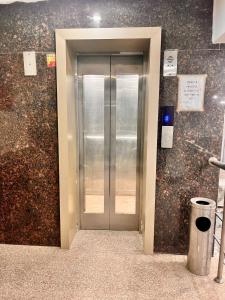 an elevator in a building with a glass door at Hotel Ramawati Near Ganga Ghat, Haridwar in Haridwār