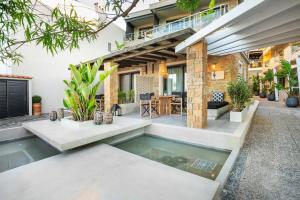 a house with a swimming pool in the yard at Adriana beach in Pefkochori