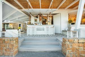 an outdoor entertaining area with a bar on a patio at Adriana beach in Pefkochori