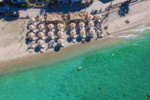 an aerial view of a beach with chairs and umbrellas at Adriana beach in Pefkochori
