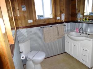 a bathroom with a toilet and a sink at Jarrah Glen Cabins in Nannup Mill +52 photos