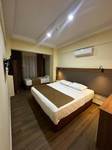 a bedroom with a large bed in a room at Fırat Otel in Marmaris