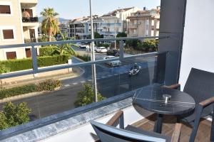 a balcony with a table and chairs and a view of a street at Fırat Otel in Marmaris