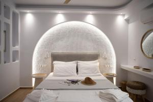 a bedroom with a bed with a hat on it at Valetta Inn in Naxos Chora