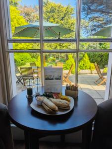 a table with a plate of hot dogs on it at Lysses House Hotel in Fareham