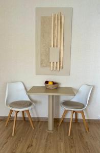 two chairs sitting next to a table with a bowl of fruit at Apartment Xenia in Xiropigado +32 photos
