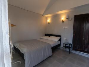 a small bedroom with a bed and a small table at Isa guesthouse in Shillong