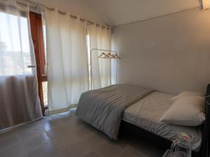 a small bedroom with a bed and a window at Isa guesthouse in Shillong