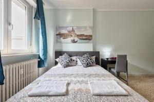 a bedroom with a bed and a desk and a window at Ca Teresa 14 in Marghera