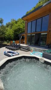 a hot tub in the backyard of a house at Lake house Emerald in Jablanica