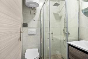a bathroom with a shower and a toilet and a sink at Apartment & Rooms - Marina in Ploče +20 photos