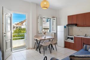 a kitchen with a table and a kitchen with a window at Driopida 5 Irida Kythnos in Mérikhas