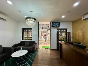 a living room with a couch and a table at Hotel Arba in Kuala Lumpur