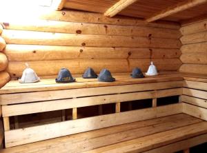 a wooden wall with a shelf with hats on it at Плакуча верба in Svityazʼ