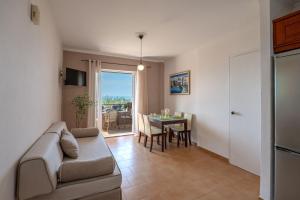 a living room with a couch and a table at Corfu Glyfada Beach Apartment 58a in Corfu