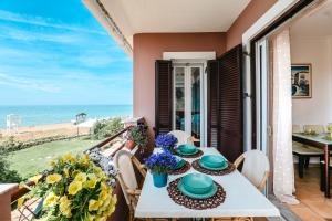 a dining room with a table and a view of the beach at Corfu Glyfada Beach Apartment 58a in Corfu
