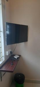 a computer monitor on a wall in a room at SRM Residency in Alāndurai