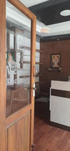 a door to a room with a skull on the wall at SRM Residency in Alāndurai