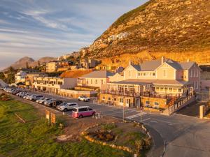 a town with cars parked in front of a mountain at Tintswalo Summer House in Glencairn