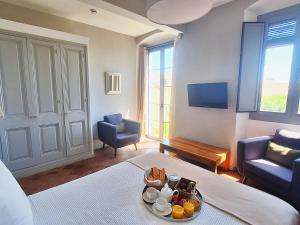 a living room with a table with a tray of food at Hotel Casa Calella in Calella de Palafrugell