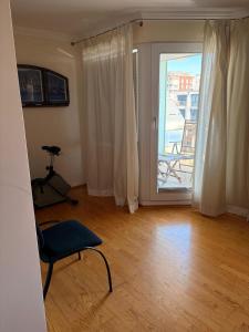 a room with a chair and a door to a balcony at Marina 38-2 in Cuxhaven