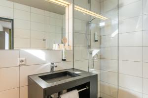 a bathroom with a sink and a shower at JOESEPP´S HOTEL am Schweizerberg in Memmingen +36 photos