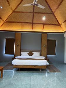 a bedroom with a large bed with a ceiling at Jawai's Wildness Lodge in Bera +91 photos