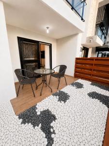 a room with a table and chairs and a rug at Modern Cozy apartment in Boca Chica