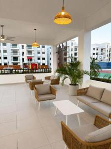 a lobby with couches and tables in a building at Modern Cozy apartment in Boca Chica