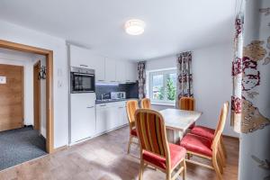 a kitchen and dining room with a table and chairs at Schwarzhans Appartments in Bludenz