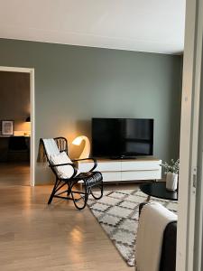 a living room with a flat screen tv on a wall at Tikka Apartments in Jyväskylä
