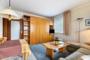 a living room with a couch and a table at Haus Passat in Büsum