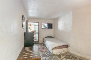 a bedroom with a bed in a room with a window at Oaxaca Venado in Agaete