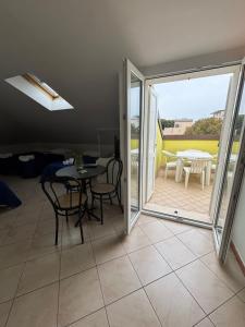 a dining room with a table and chairs and a patio at Hotel Dream in Rimini