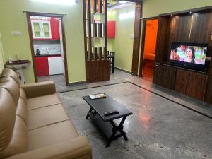 a living room with a couch and a coffee table at wonderful stays in Tirupati +1 photo