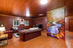 a living room with a couch and a large painting at The Murray River Weekender in Ulupna West