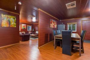 a dining room with a table and a living room at The Murray River Weekender in Ulupna West