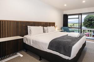 a bedroom with a large bed and a large window at Alpine Chalets in National Park