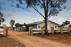 a house with a tree in front of it at The Murray River Weekender in Ulupna West
